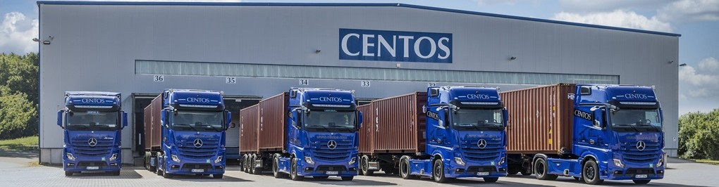Bild einer Centos Lagerhalle mit blauen LKWs